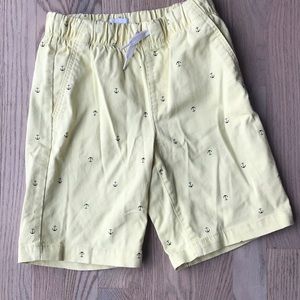 Boys pull on shorts with anchors